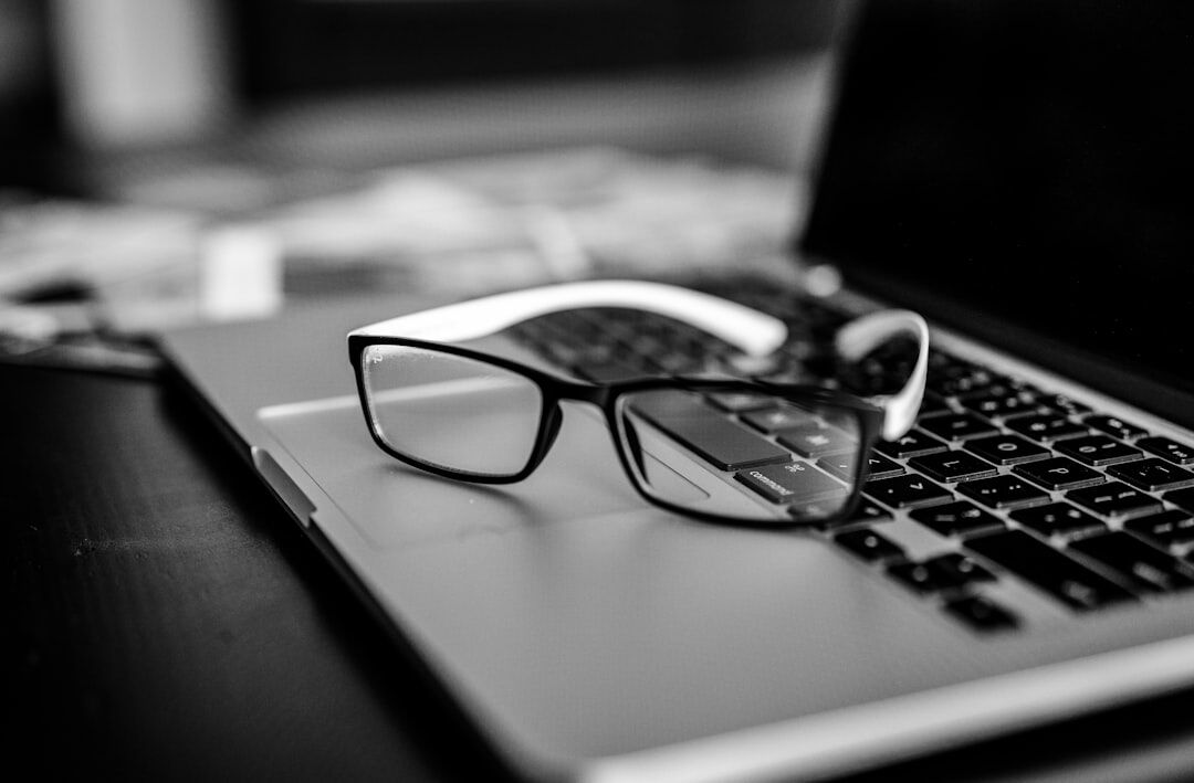 Investigative journalist's desk with documents, a laptop and a magnifying glass